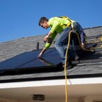 Solar installer on residential roof; photo courtesy of RAZE Solar