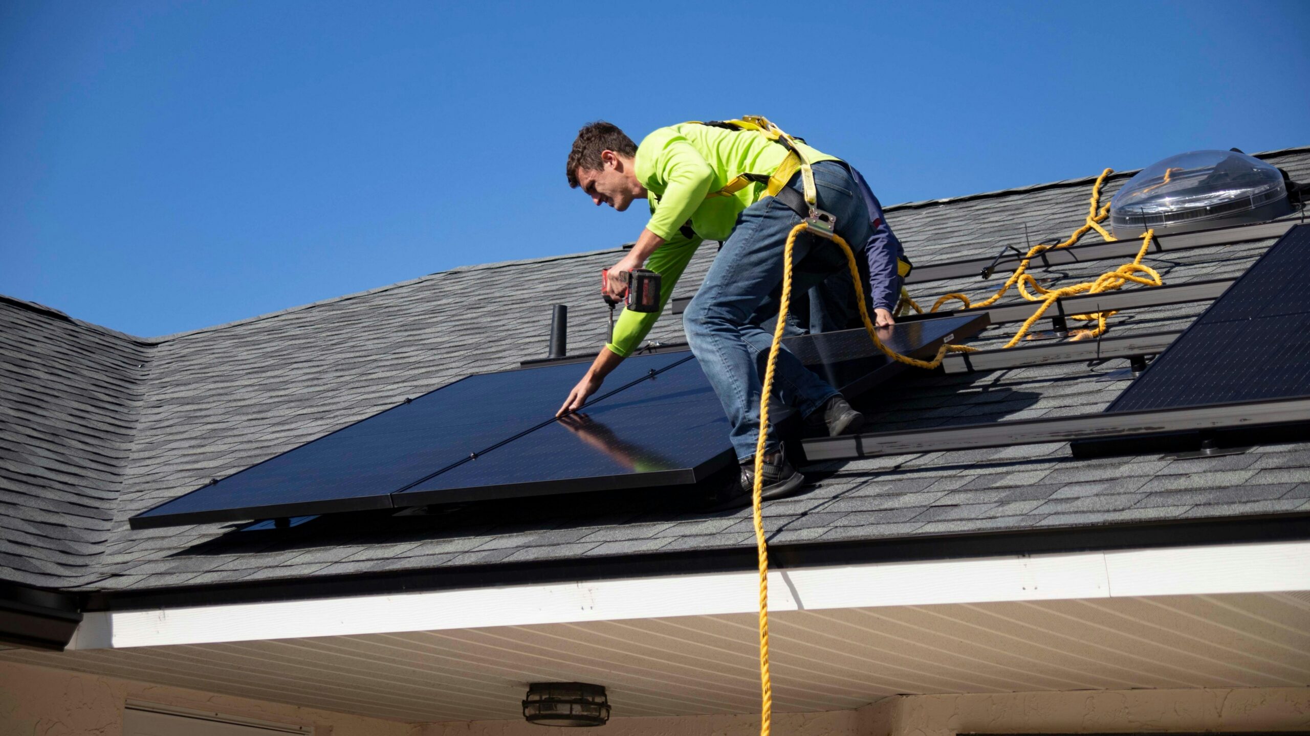 Solar installer on residential roof; photo courtesy of RAZE Solar