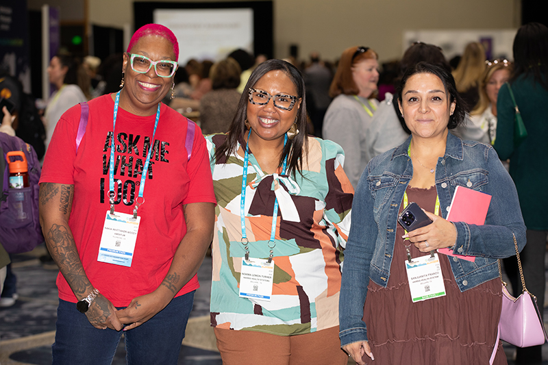 Group of three women smiling for the camera